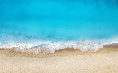 Beach and waves from top view. Turquoise water background from top view. Summer seascape from air....