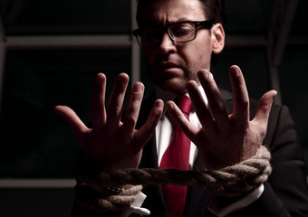 close up.businessman looks at his hands tied