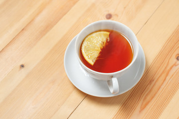 Cup of tea with lemon on the wooden table