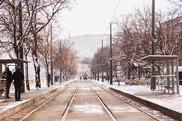 Yellow tram and rails on the embankment from Buda side in winter in Budapest, Hungary
