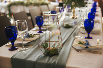 Table appointsment in restaurant. Wedding decoration in blue style