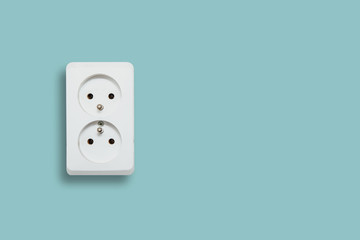 White electric socket on blue pastel background. The concept of electric power consumption, use of...
