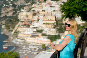 Young blonde woman in european city walking. Tourist