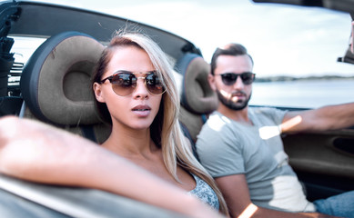 close up.the couple traveling in a convertible