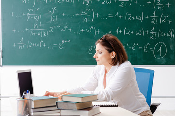 Female math teacher in front of the chalkboard 