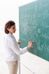 Female math teacher in front of the chalkboard 