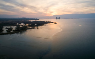 Aerial view of a nuclear powerplant in the city of Energodar, Ukraine. Winter landscape, sunset sky.