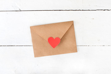 love letter envelope with red heart on white wooden background 