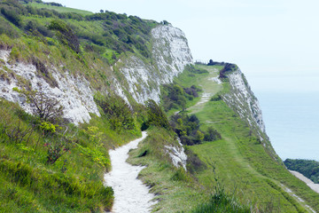 Coastal walking path on top of white chalk cliffs, overlooking the English Channel, Dover, Kent,...