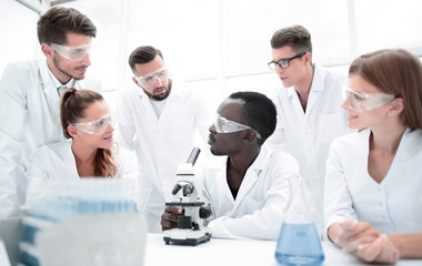 Fototapeta premium Focused and serious female and male chemists in lab coats and sa