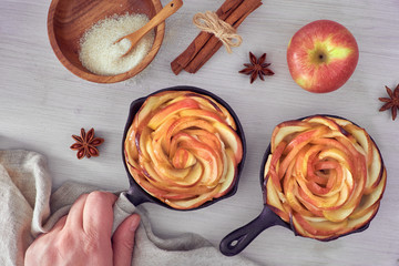 Homemade puff pastry with rose shaped apple slices baked in iron skille