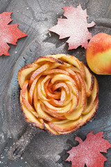 Homemade puff pastry with rose shaped apple slices baked in iron skillet