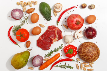 Healthy food clean eating selection: fruit, vegetable, seeds, fish, meat, leaf vegetable on white background. Top view.