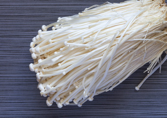 Bunch of japanese enoki mushrooms on dark background