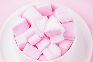 Love theme. Pink marshmallow hearts in a cup. Valentine's day background. Copy space