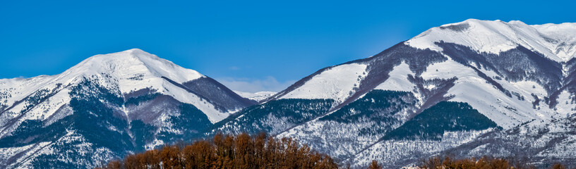 Fototapeta na wymiar wide panorama of the Italian Marsicani mountain range covered by snow in January