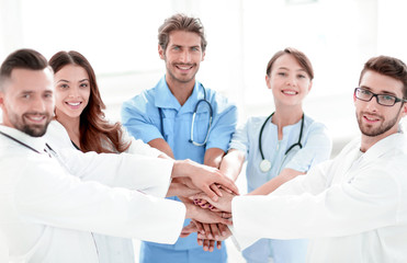 Doctors and nurses stacking hands. concept of mutual aid.