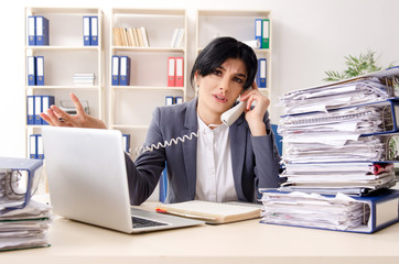 Middle aged businesslady unhappy with excessive work 