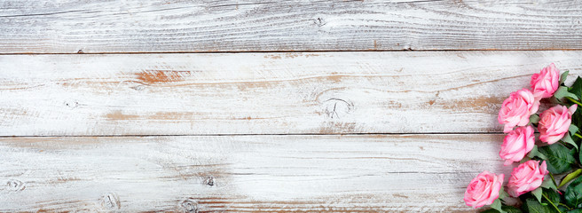 Spring still life with Mothers Day holiday concept on white rustic wood background with pink rose...