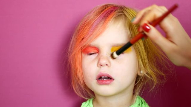 Little blonde does makeup. Bright fashion video