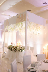 Floral elements of roof. Decorated chandelier on wedding