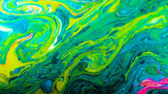 Green psychedelic abstract bright colors are mixed in a liquid