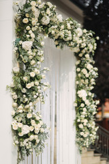 Arch decorated with flowers at the wedding caremony
