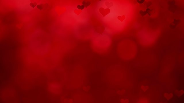 Beautiful red colored valentine day background with heart shapes in slow motion.