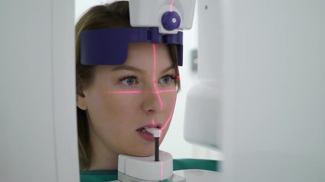 Woman patient in X-ray machine scanner in medical cabinet in hospital. Work place of doctor in clinic. Healthcare