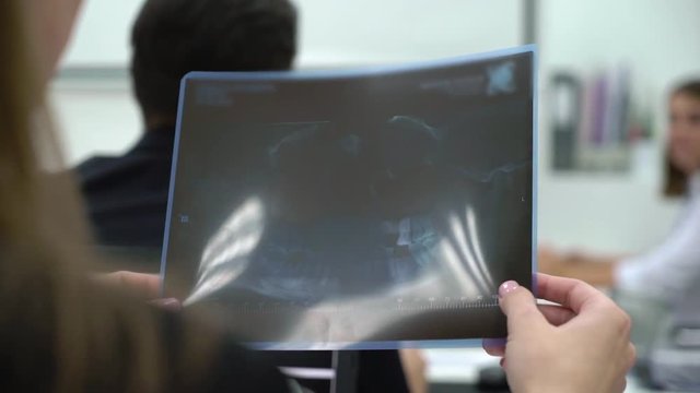 Medical student doctor holding X-ray film of teeth and jaw. Medicine university