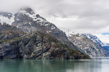 Naklejka na ściany i meble Johns Hopkins Glacier and mountains on a cloudy day in Glacier Bay, Alaska