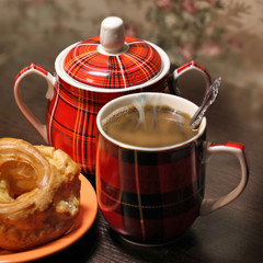 Mug with hot coffee standing on the table