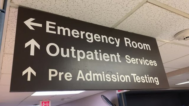 Sign showing directions in hospital hallway