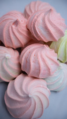 Sweet dessert on a light background. Pink and green Marshmallows. Vertical photography. Desserts for healthy diet. Slavic cuisine.