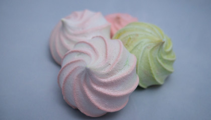 Sweet dessert on a light background. White, pink and green Marshmallow (Zefir). Desserts for healthy diet.