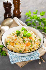 Bulgur wheat boiled with carrot, green peas and corn, healthy vegan diet