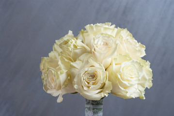 Wedding buequet with white roses on gray background. Close up