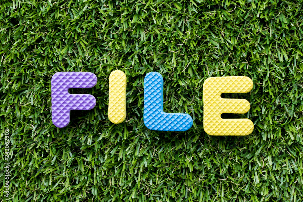 Sticker Color alphabet letter in word file on artificial green grass background