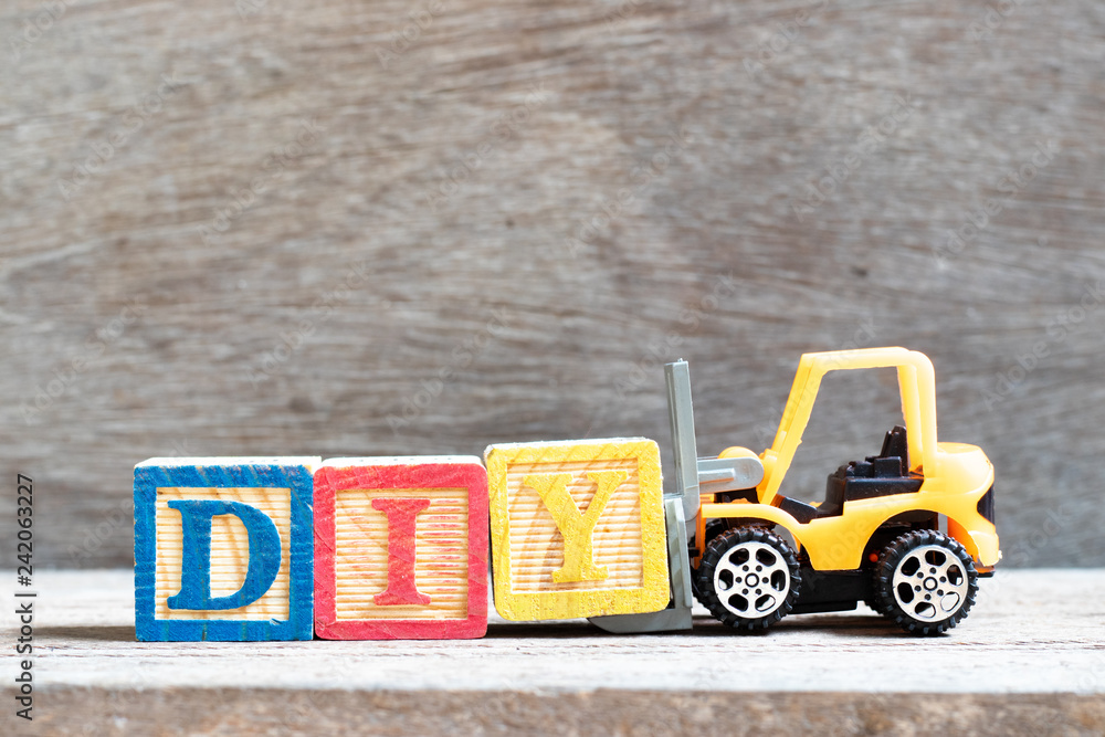 Canvas Prints Toy forklift hold letter block Y to complete word  DIY (abbreviation of do it yourself) on wood background