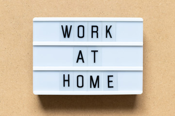 Obraz premium White lightbox with word work at home on wood background