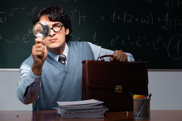 Young math teacher in front of chalkboard