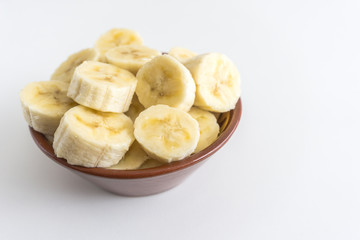 Fototapeta na wymiar Bowl with banana slices on white background