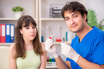 Doctor getting saliva test sample in clinic hospital