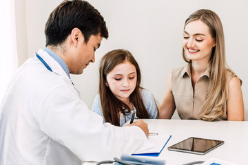 Fototapeta premium Doctor consulting and check up information with little girl in hospital.A little girl has sick.healthcare and medicine