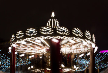 Children's Carousel in the evening and night illumination. Spinning retro carousel