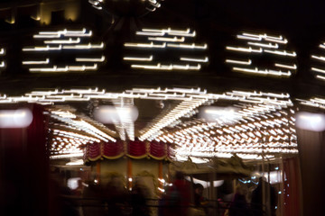 Children's Carousel in the evening and night illumination. Spinning retro carousel