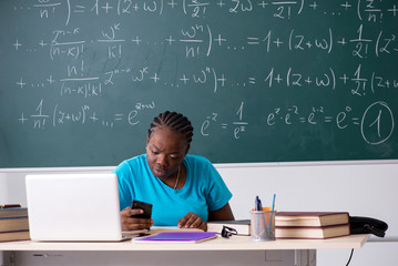Black female student in front of chalkboard  