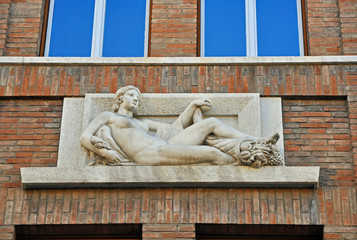 Italy  Ravenna young lady sculpture on the National Insurance Institute building. Example of architecture during fascism.