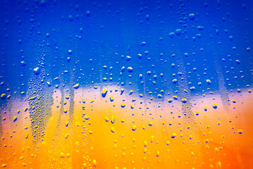 rain drops on the colorful window glass 