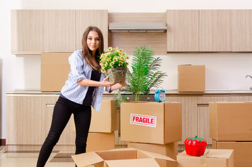 Young beautiful woman moving to new flat